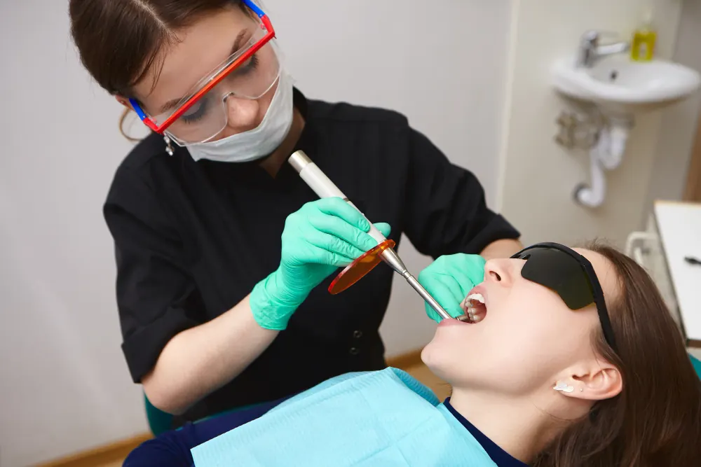 Dentist performing a professional scale and clean treatment on a patient in Highton.