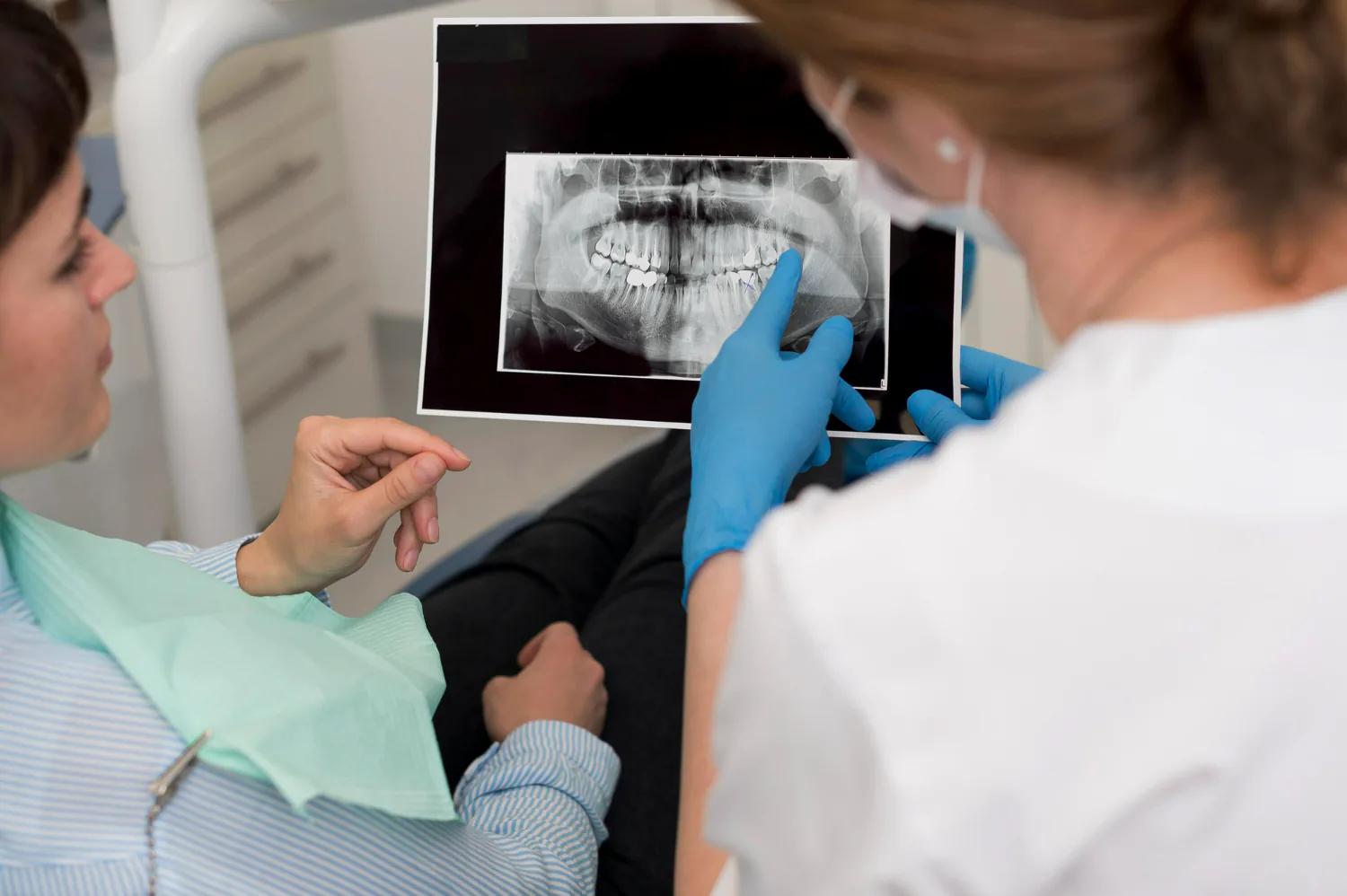 Dentist showing the X-ray to the patient.