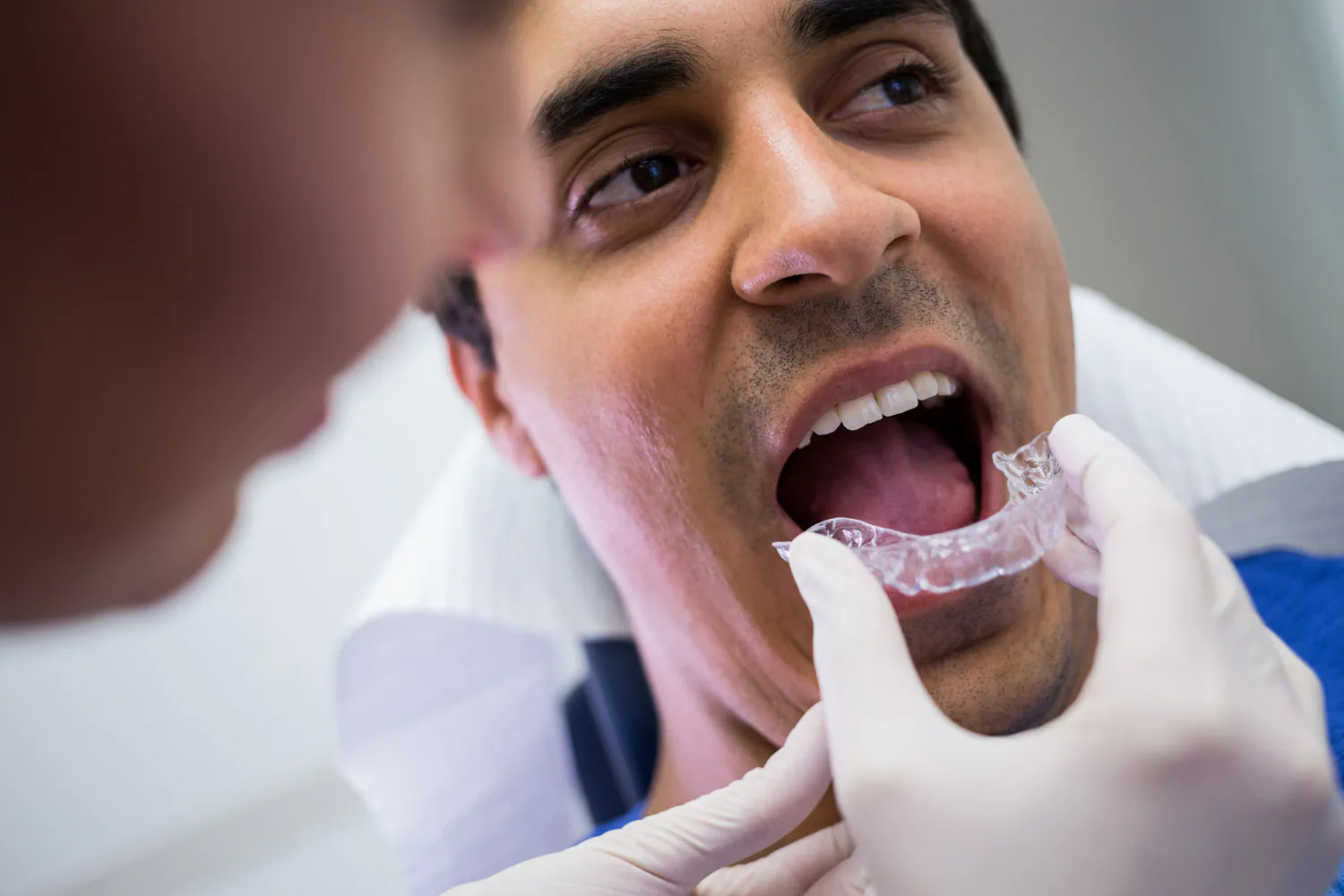 Patient receiving custom fitted aligners for a more comfortable fit.