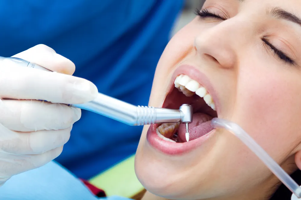 A patient receiving a professional scale and clean treatment from a dentist.
