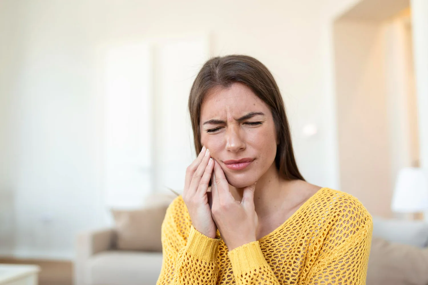 Patient experiencing tooth sensitivity.