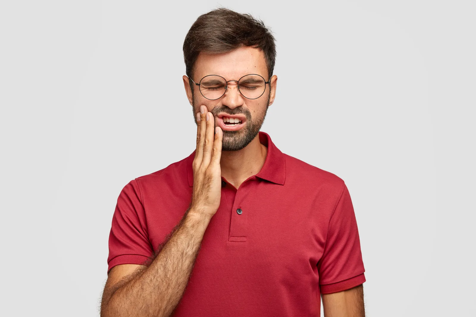 Person experiencing toothache before a dental check-up.
